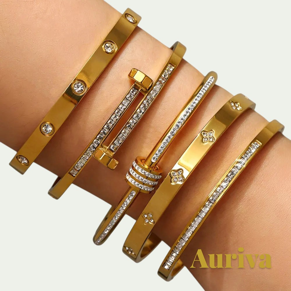 Gr8est Auriva gold titanium steel stacked bangles featuring cubic zirconia pave and flower motifs on a wrist