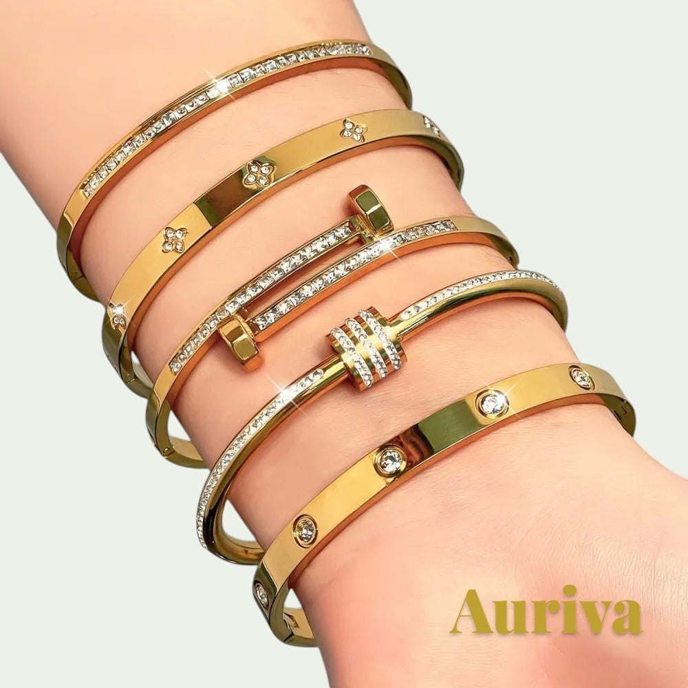 Gr8est Auriva gold titanium steel stacked bangles featuring pave-set cubic zirconia and flower motifs on a wrist.