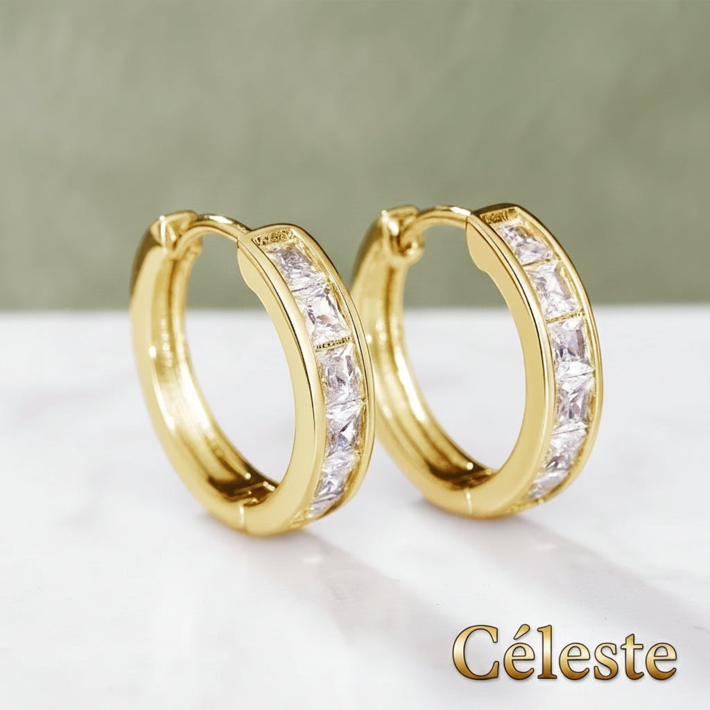 Gr8est Céleste gold-tone hoop earrings featuring princess-cut cubic zirconia stones in a geometric design.