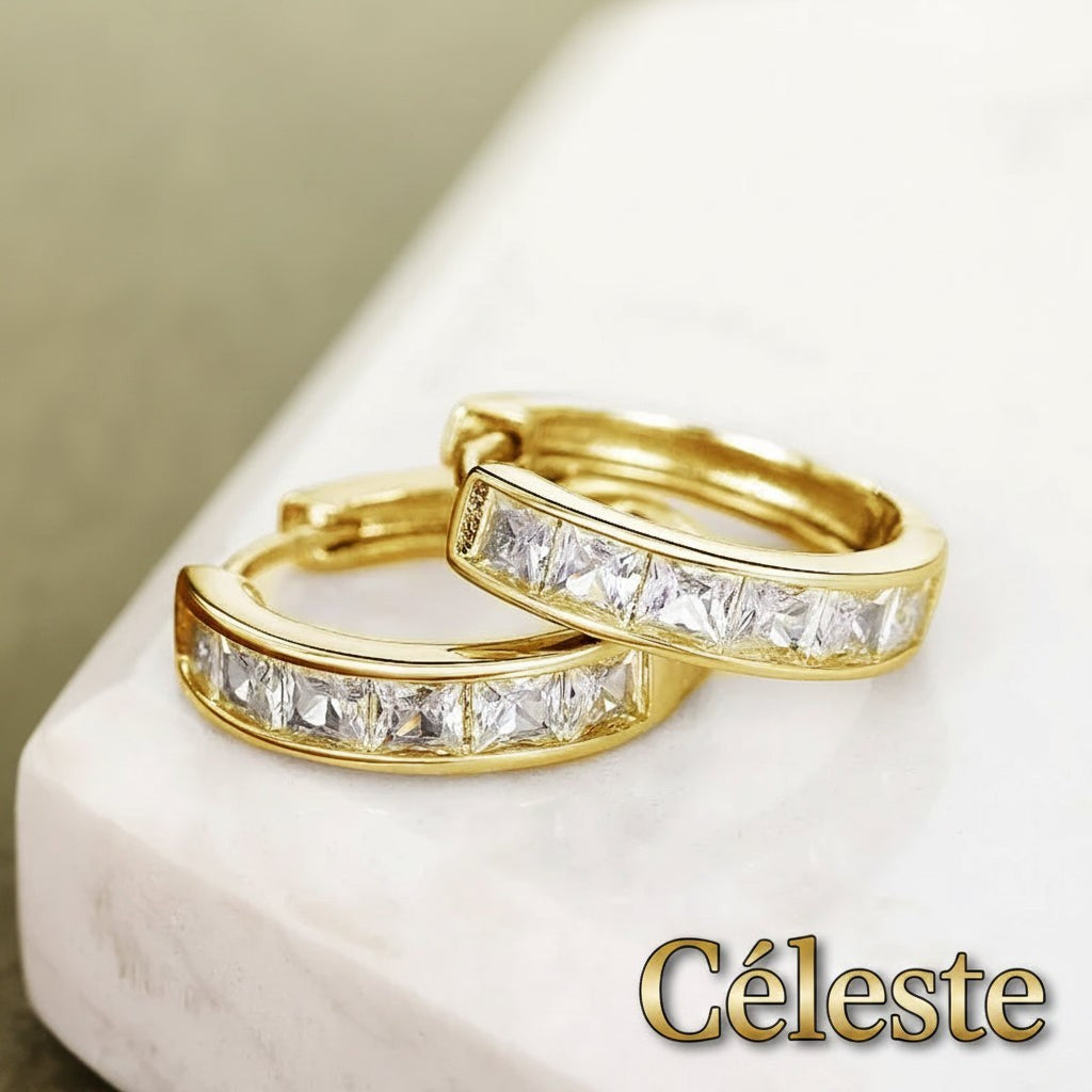 Gr8est Céleste gold-tone hoop earrings featuring princess-cut cubic zirconia stones in a classic geometric design.