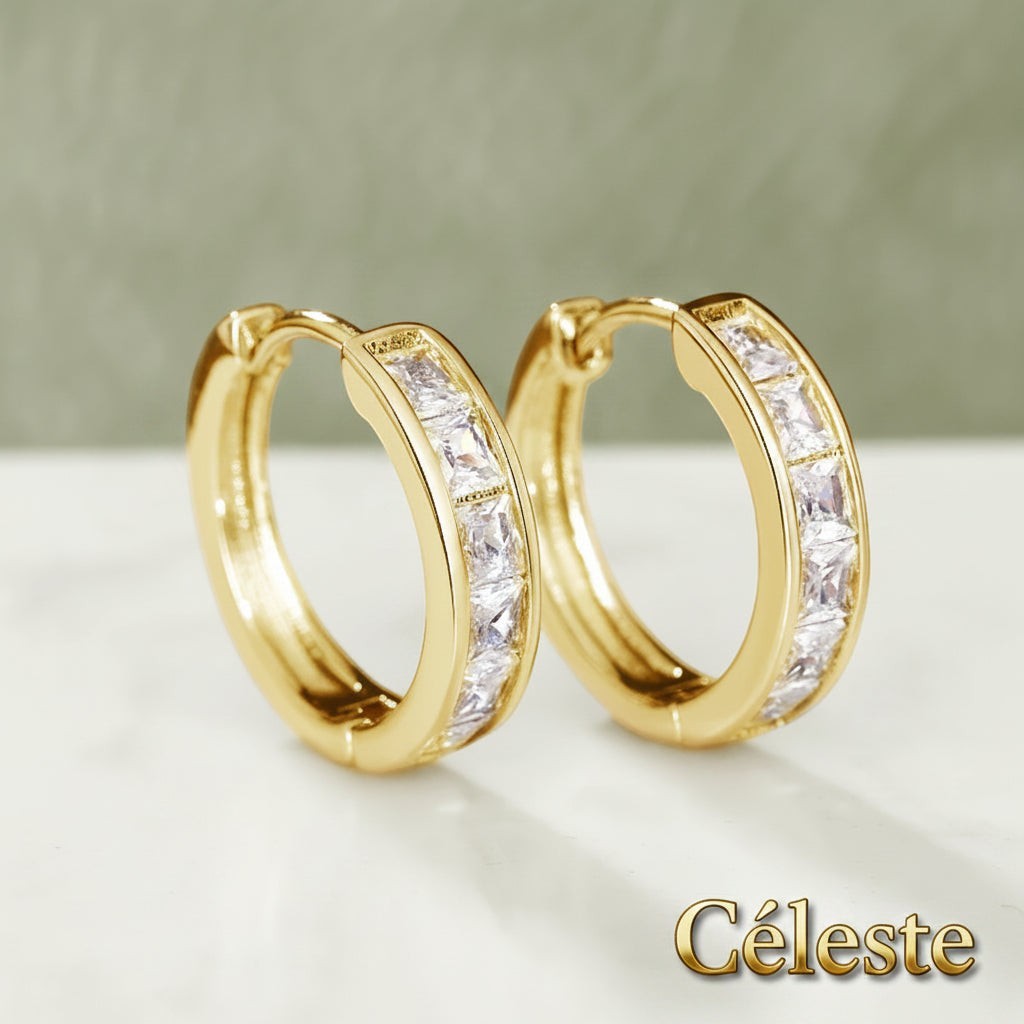 Gr8est Céleste gold-tone hoop earrings featuring princess-cut cubic zirconia stones in a classic geometric design.