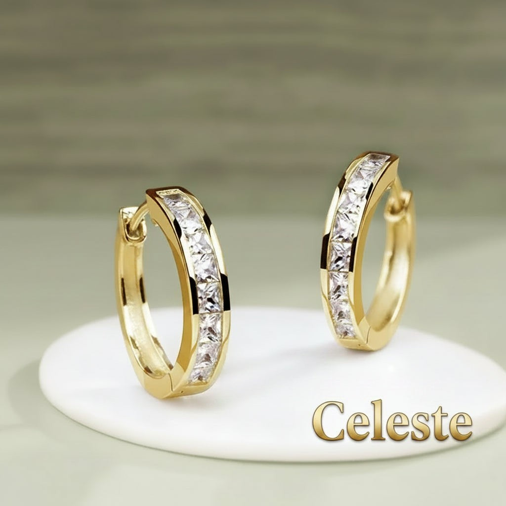Gr8est Céleste gold-tone hoop earrings featuring a row of sparkling princess-cut cubic zirconia stones.