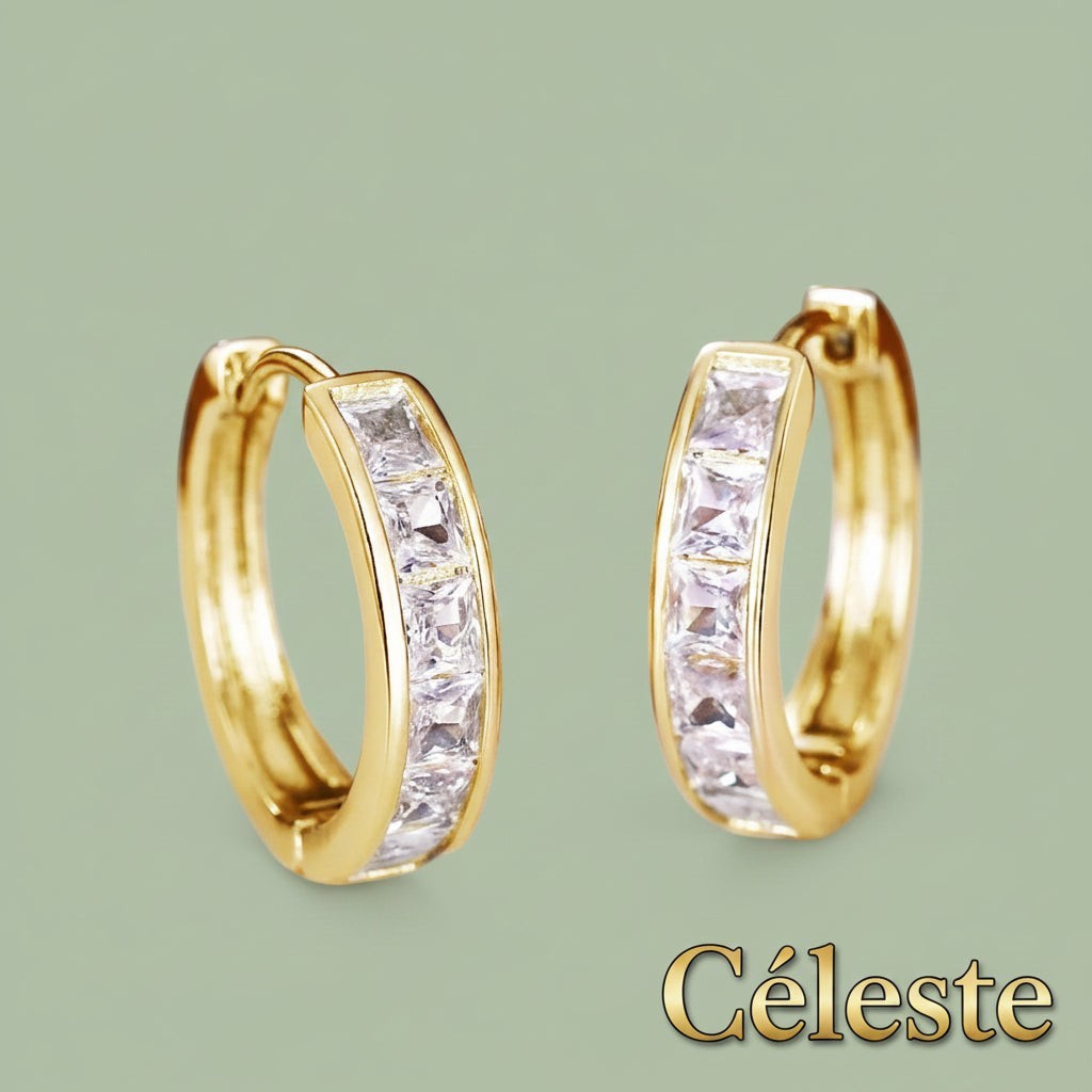 Gr8est Céleste gold-tone hoop earrings featuring princess-cut cubic zirconia stones in a classic geometric design.