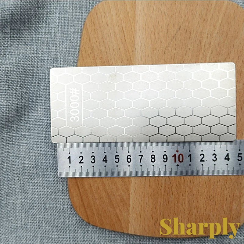 Gr8est diamond sharpening stone with a hexagonal pattern and 3000 grit rating on a wooden cutting board