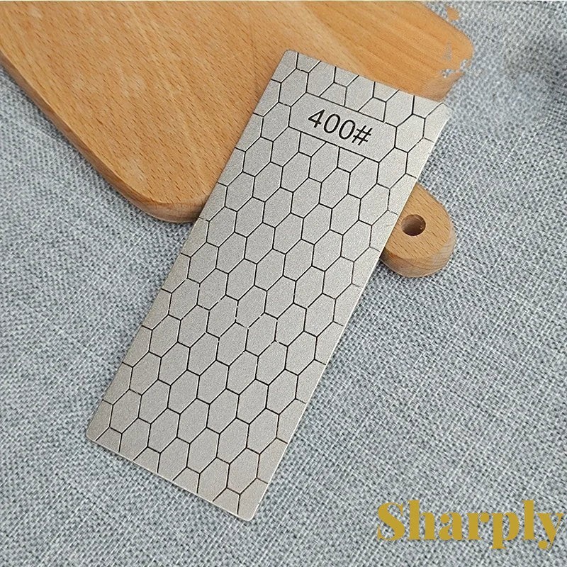 Gr8est diamond knife sharpening stone with a 400 grit hexagonal pattern surface on a wooden board.