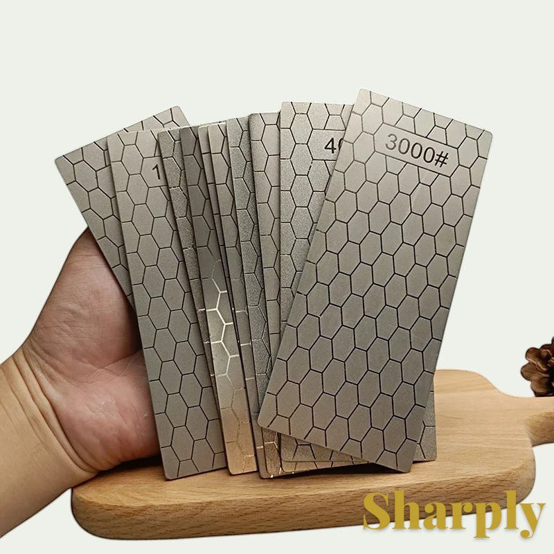 Gr8est Sharply diamond knife sharpening stones with a hexagonal pattern, held in a hand over a wooden board.
