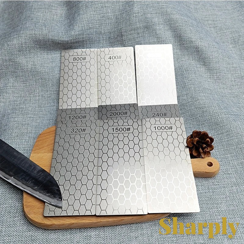 Gr8est diamond knife sharpening stones with various grit levels and a honeycomb pattern on a wooden board.