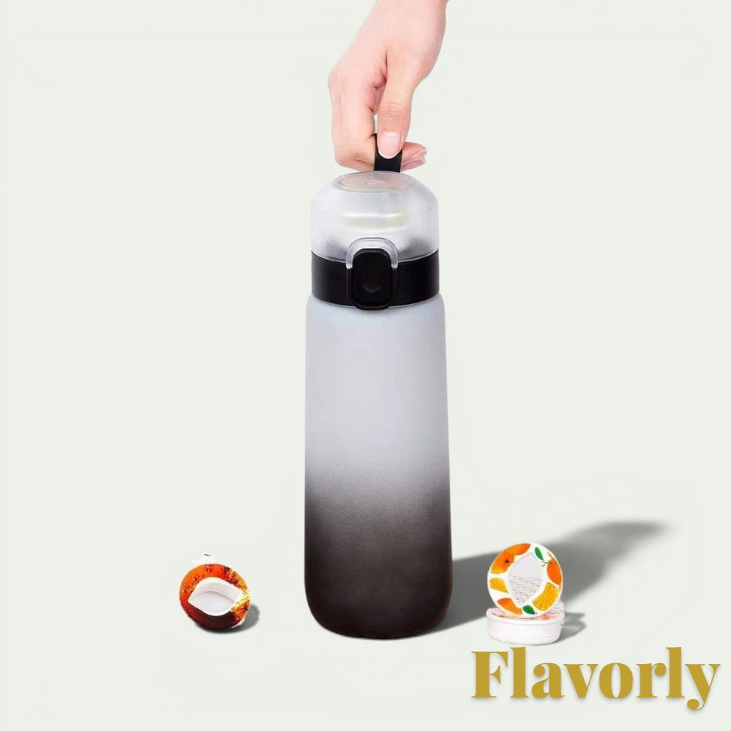 Gr8est Flavorly frosted black 650ml scent pod water bottle held by a hand with two flavor pods on the surface.