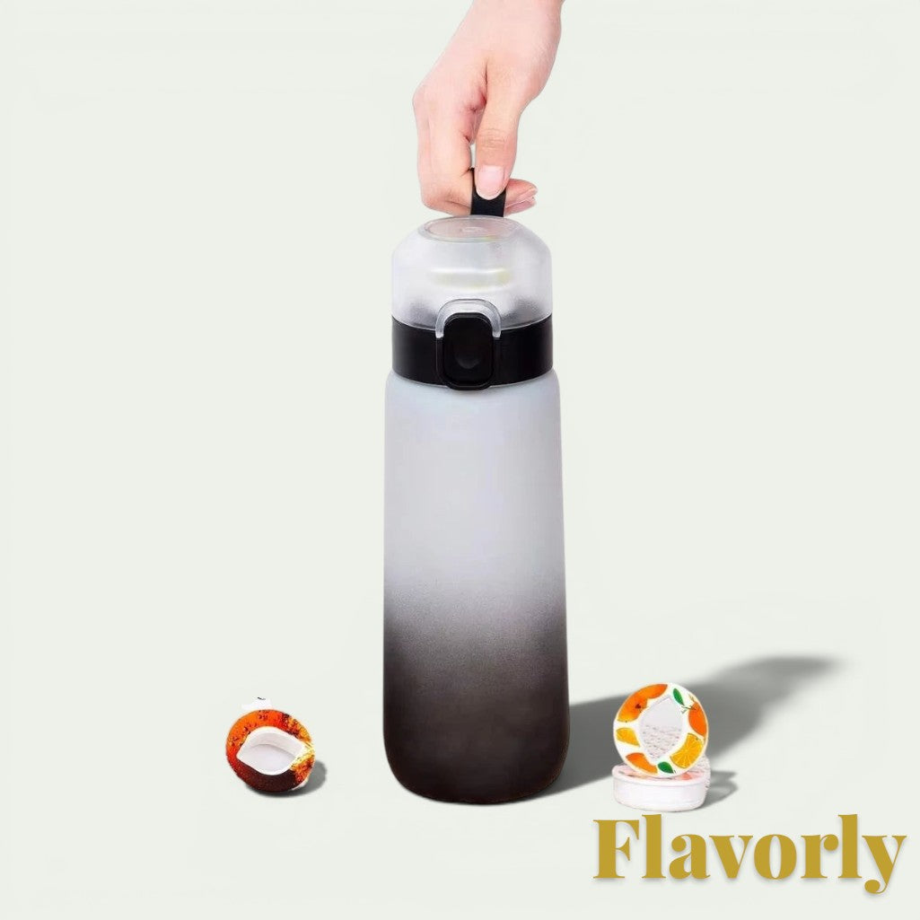 Gr8est Flavorly frosted black 650ml scent pod water bottle held by a hand with two flavor pods on the surface.