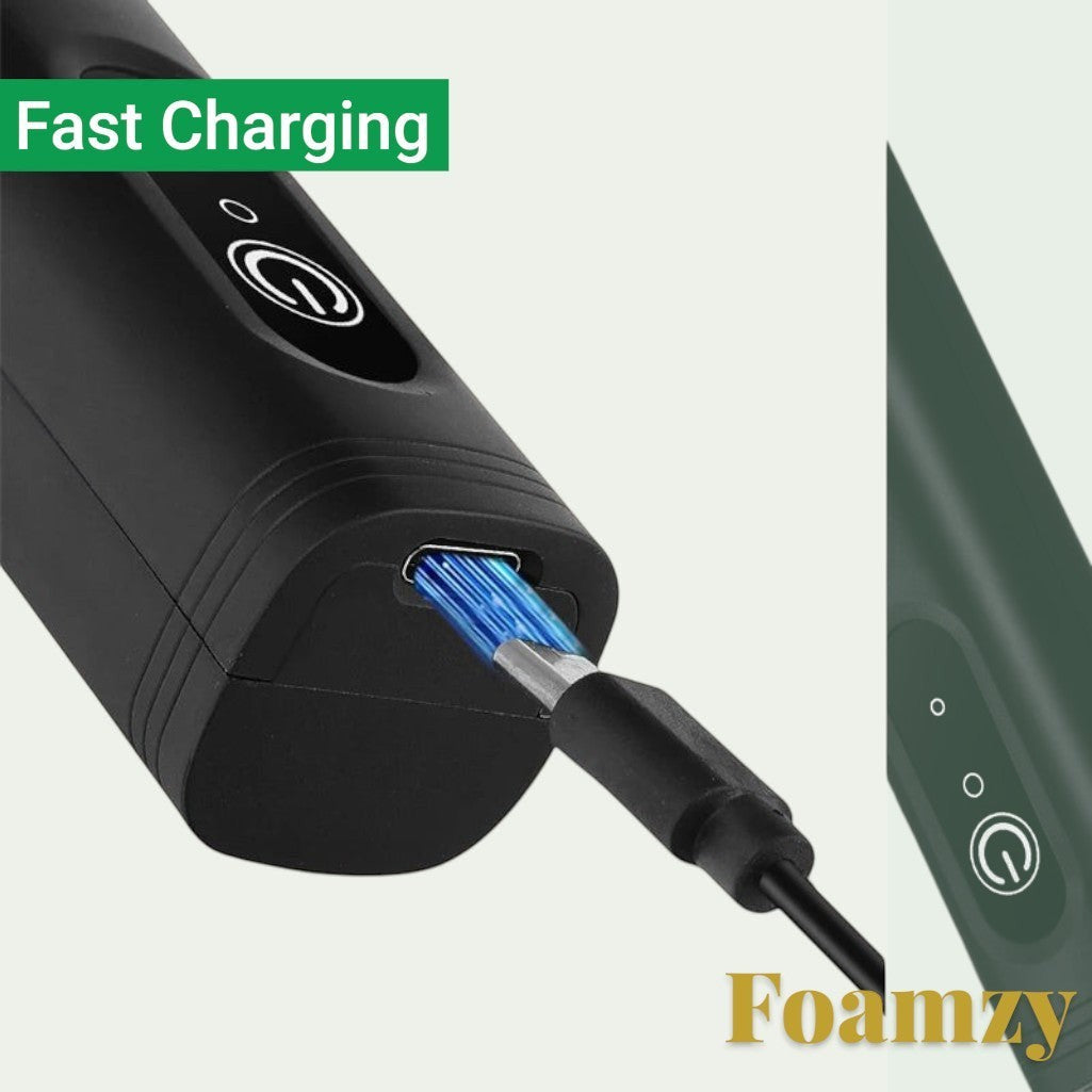 Gr8est Foamzy electric milk frother being charged with a USB cable, showing the fast charging port and power button.