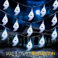 Gr8est BooBeam ghost-shaped LED string lights glowing against a spooky haunted house backdrop for Halloween decor
