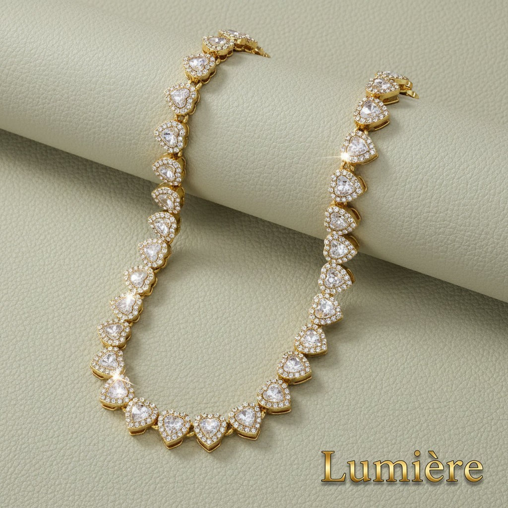 Gr8est gold tone heart tennis necklace with sparkling rhinestones on a textured sage green background