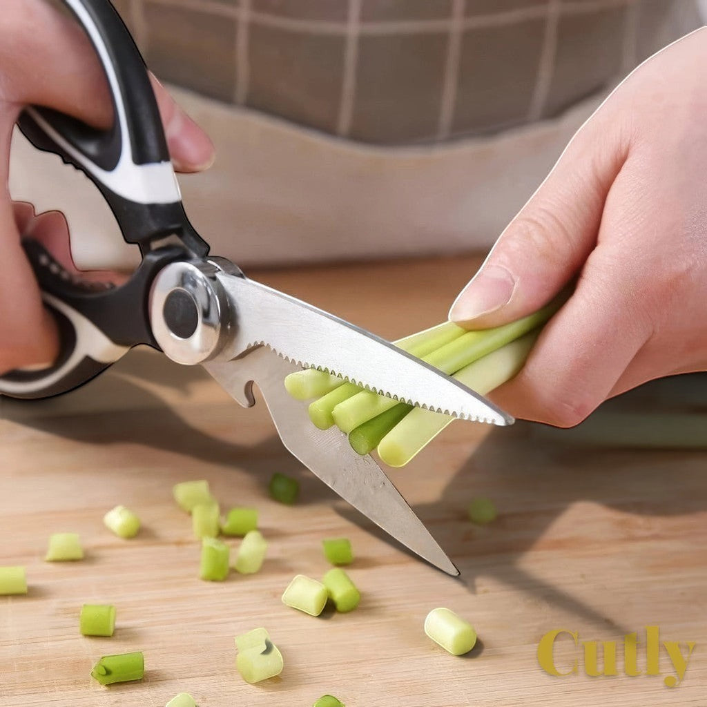 Gr8est heavy-duty kitchen shears with stainless steel serrated blades cutting green vegetables on a wooden board