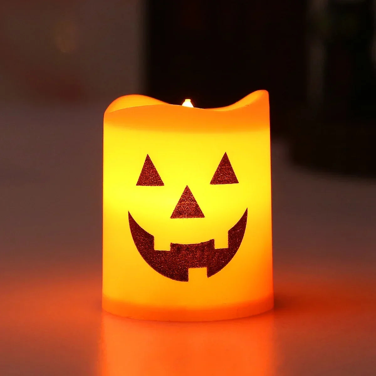 Gr8est battery-powered LED pumpkin candle with a spooky jack-o-lantern face in orange-yellow plastic