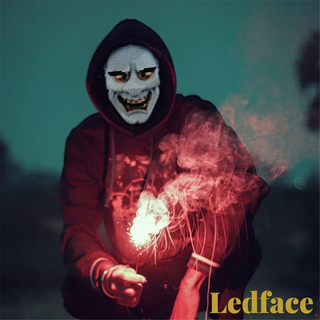 Gr8est Ledface Bluetooth RGB LED mask worn by a person in a hoodie holding a sparkler for a rave or cosplay event