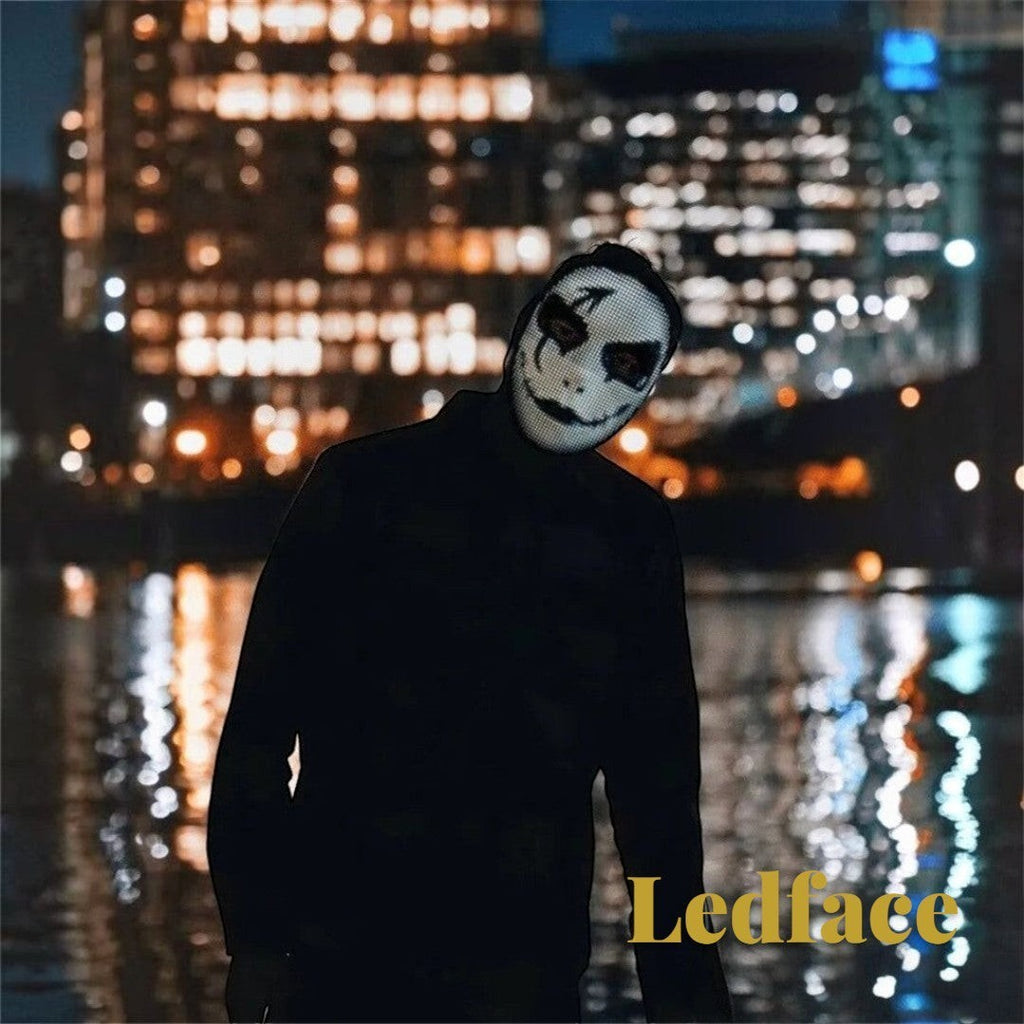 Gr8est Ledface Bluetooth RGB LED mask showing a spooky digital face design at night with city lights in the background