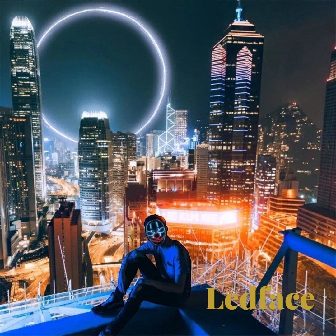 Gr8est Ledface Bluetooth RGB LED mask worn by a person on a city rooftop at night with a glowing neon ring background