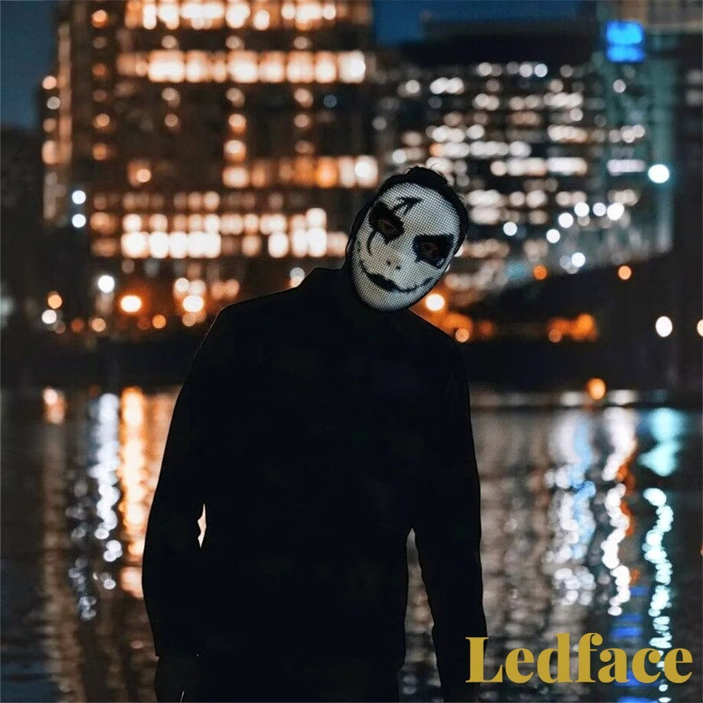 Gr8est Ledface Bluetooth RGB LED mask showing a spooky digital face design at night with city lights in the background