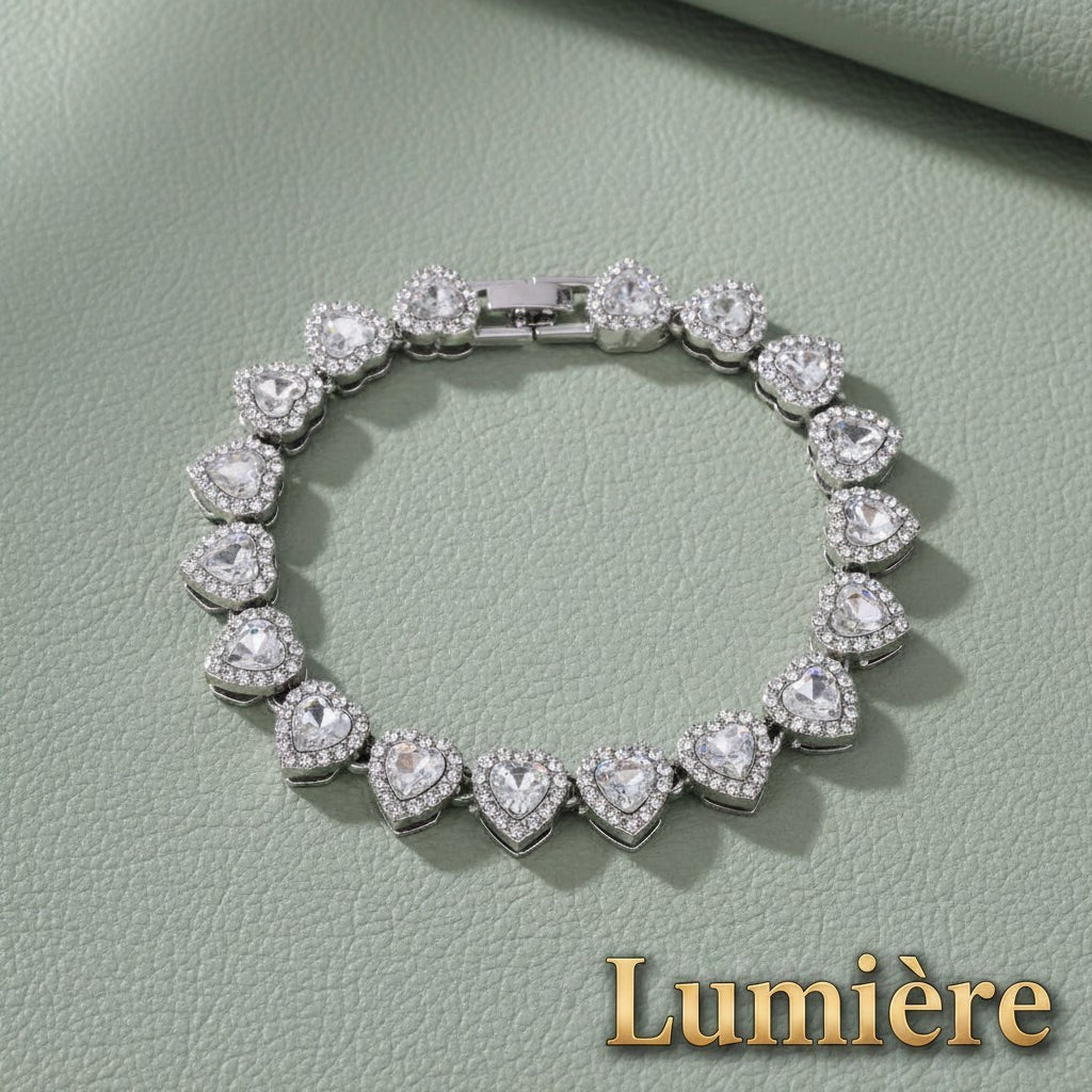 Gr8est Lumière heart tennis bracelet in silver-tone zinc alloy with sparkling clear rhinestones on a sage green surface