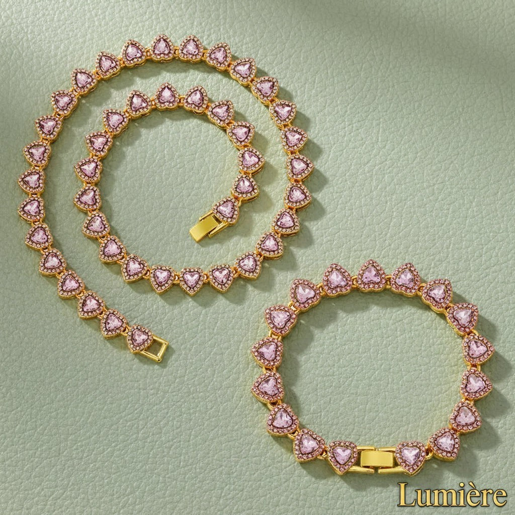 Gr8est Lumière heart tennis chain set featuring pink rhinestone hearts on a gold-tone metal necklace and bracelet.