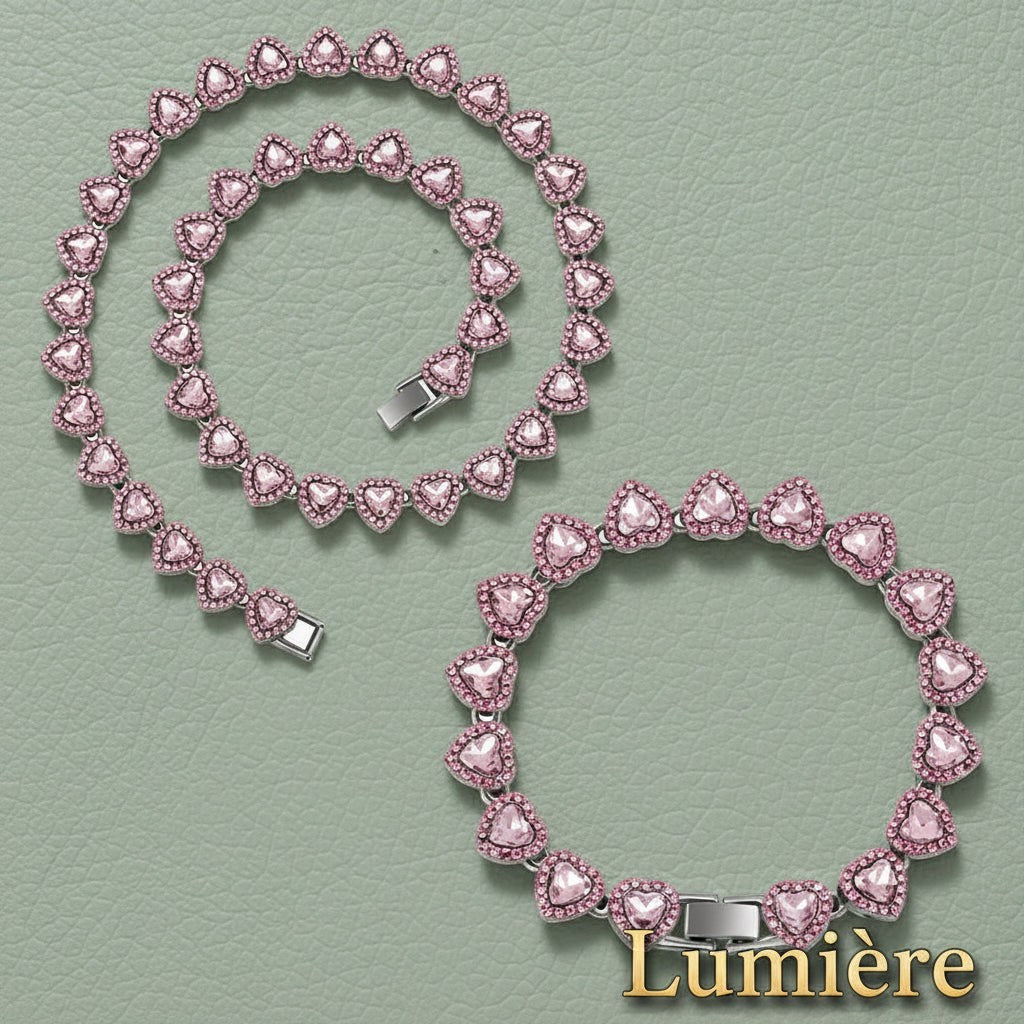 Gr8est Lumière heart tennis chain set featuring pink rhinestone heart links in a necklace and bracelet combination.