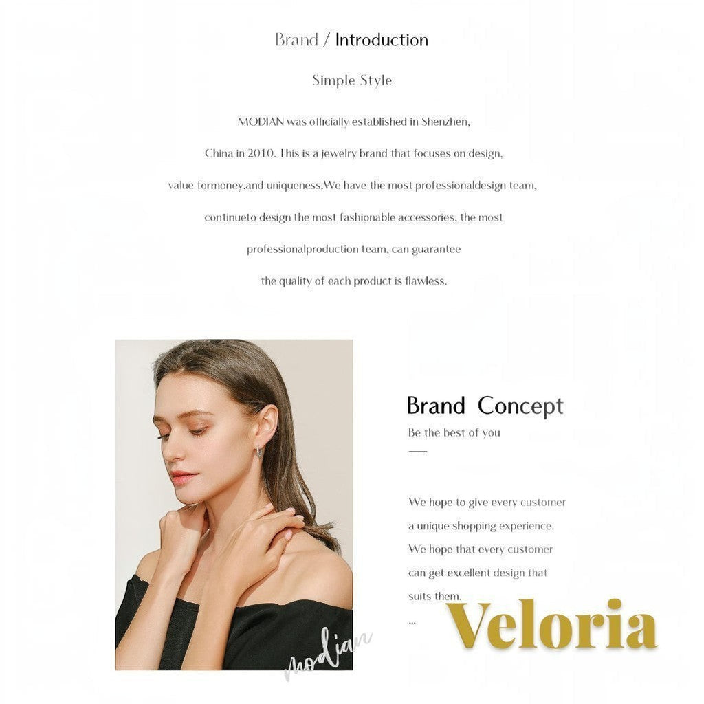 Gr8est model wearing elegant jewelry with an off-shoulder top, showcasing a sophisticated and minimalist style.
