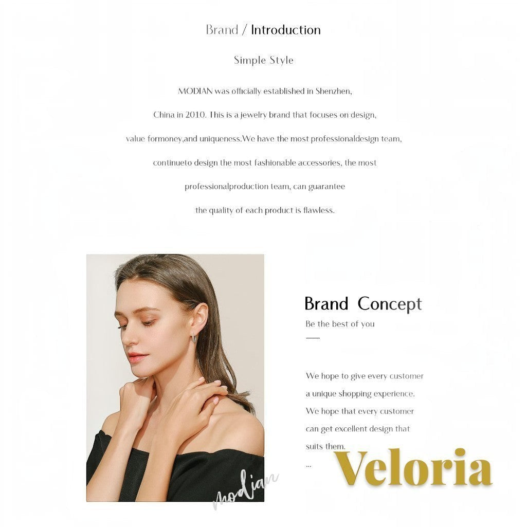 Gr8est model wearing elegant jewelry with an off-shoulder top, showcasing a sophisticated and minimalist style.