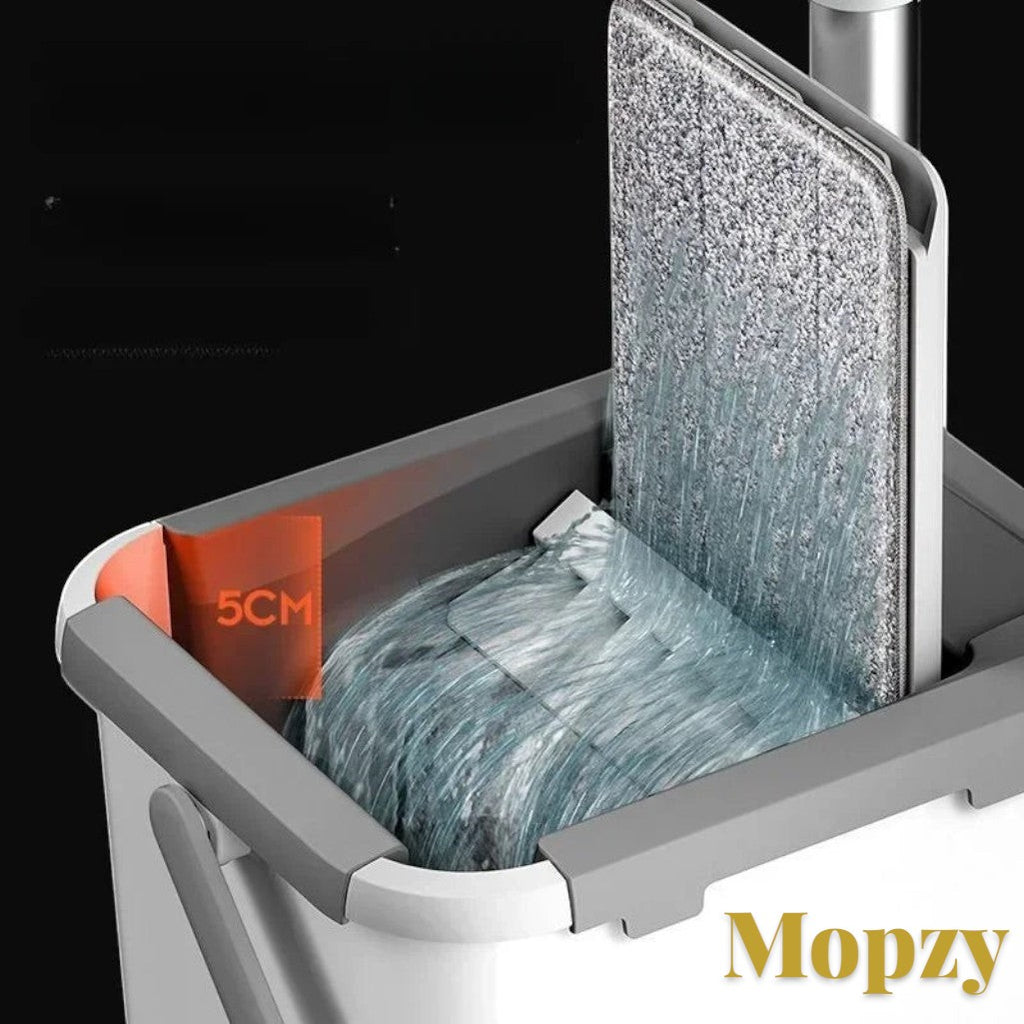 Gr8est Mopzy spin mop and bucket set with a grey microfiber head being rinsed in a self-wringing cleaning system.
