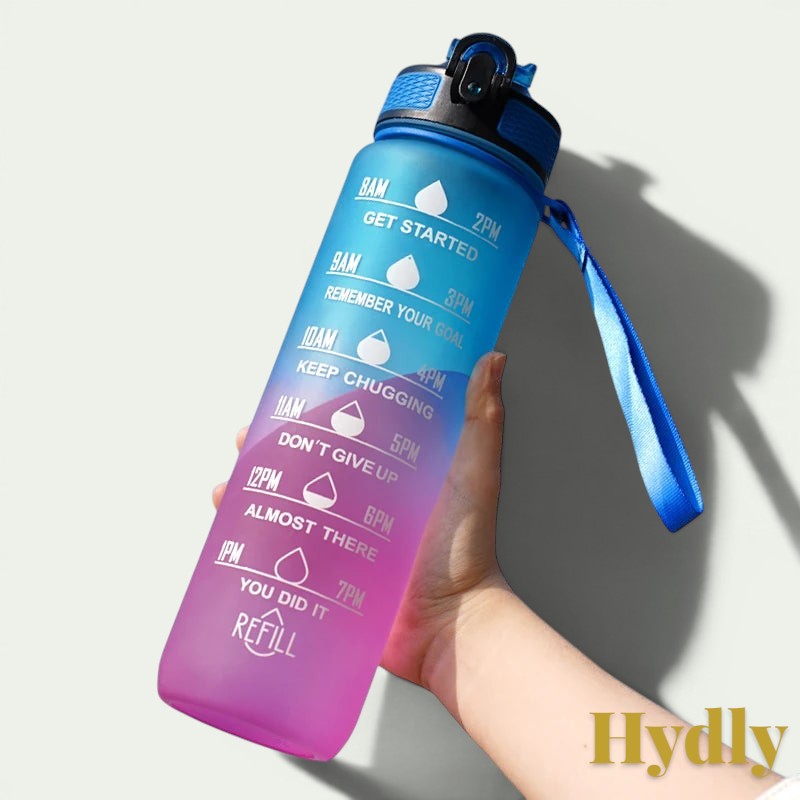 Gr8est 1L motivational water bottle in blue and pink gradient with time markers, straw, and carrying strap.