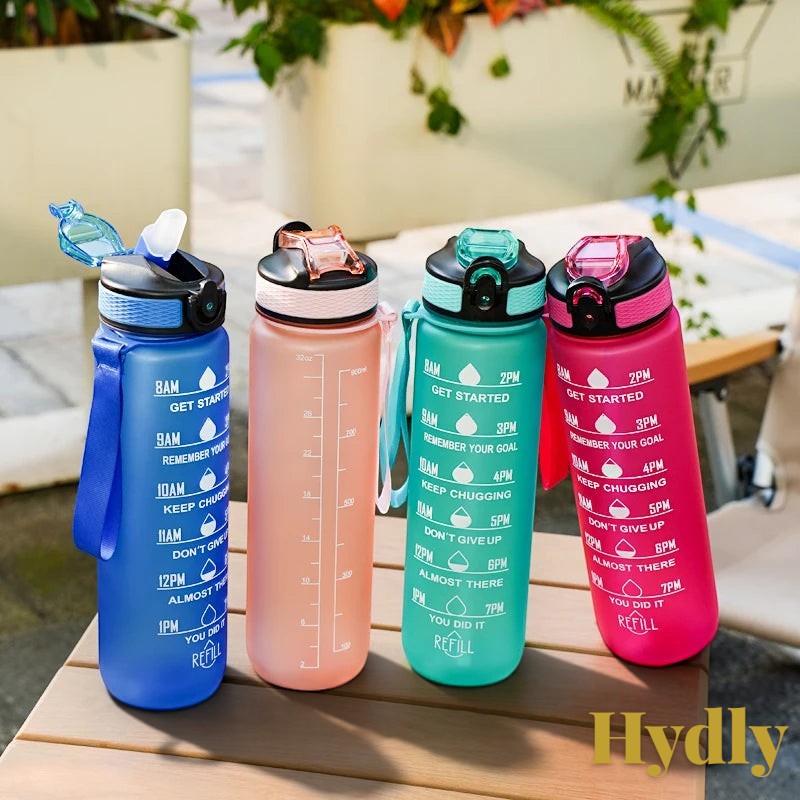 Gr8est 1L motivational water bottles with time markers, straws, and leak-proof lids in blue, pink, teal, and magenta.