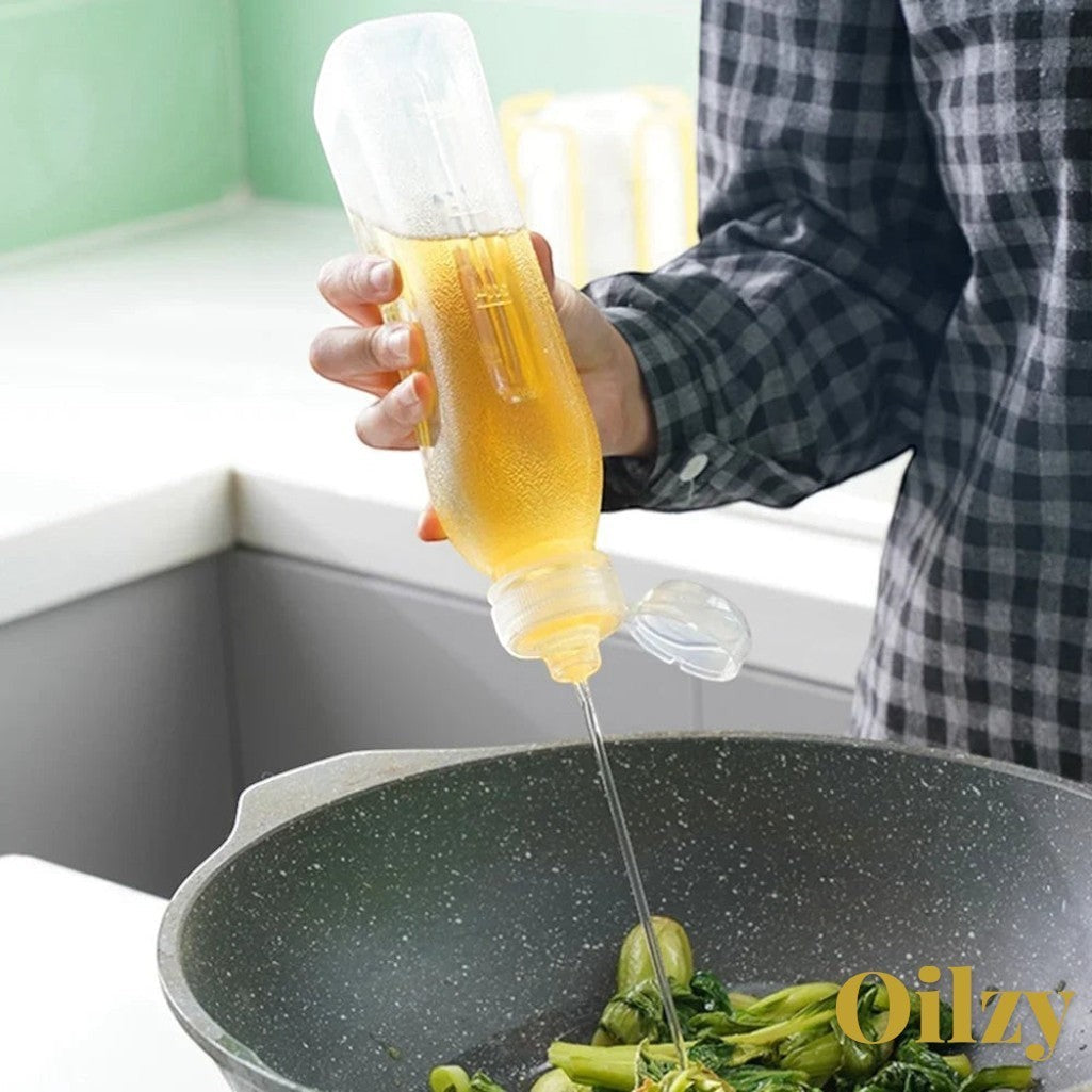 Gr8est Oilzy kitchen oil dispenser bottle pouring oil into a pan for healthy cooking and even coating.