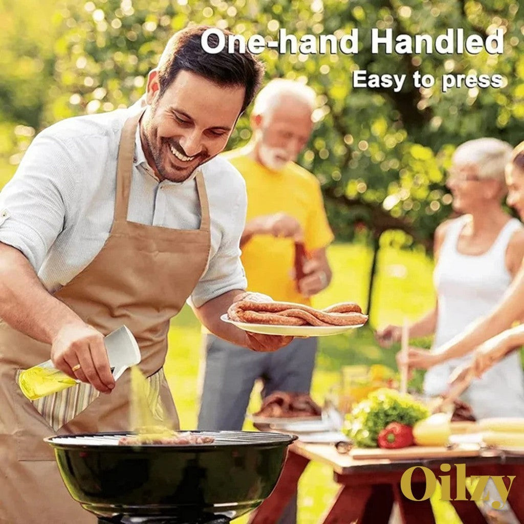 Gr8est Oilzy kitchen oil spray bottle used by a man grilling sausages outdoors for a healthy cooking experience