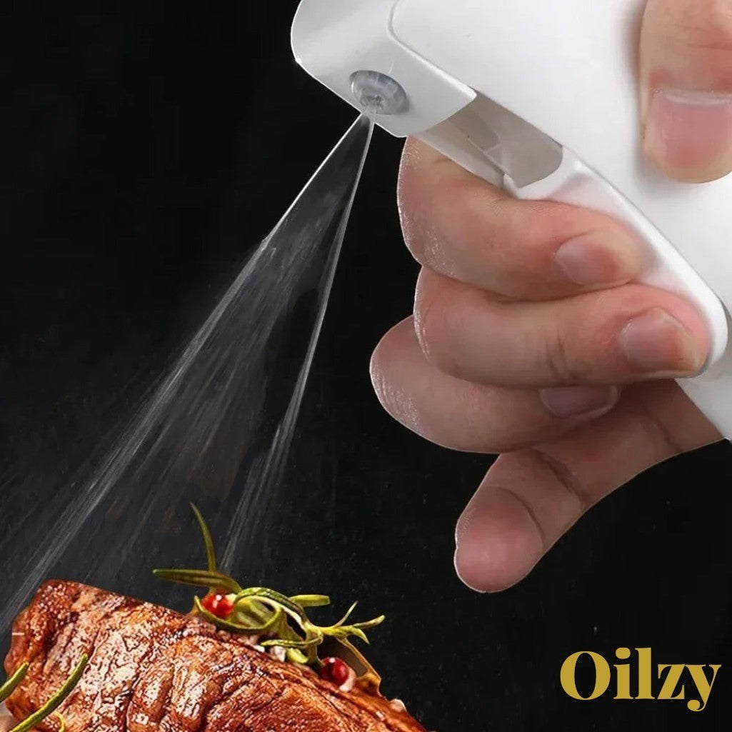 Gr8est Oilzy kitchen oil spray bottle misting olive oil onto a grilled steak for even cooking
