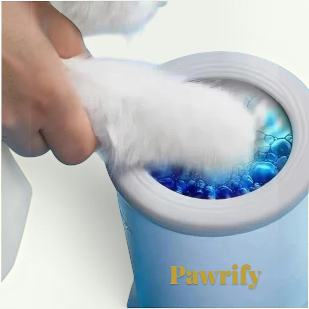 Gr8est Pawrify electric dog paw washer in blue cleaning a white dog paw with gentle silicone bristles