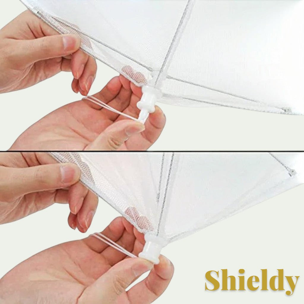Hands operating the Gr8est pop-up food mesh cover mechanism to protect meals from insects.