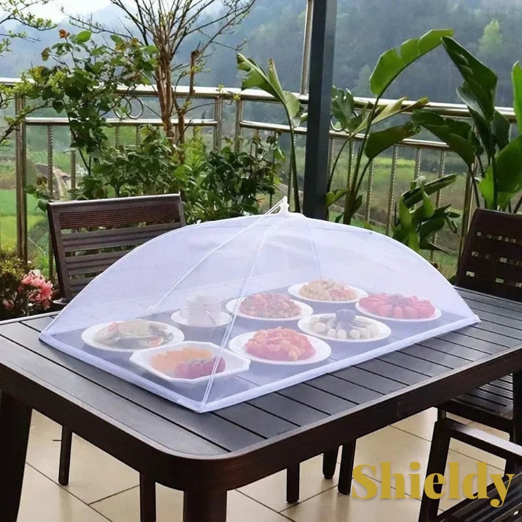 Gr8est white pop-up mesh food cover protecting plates of food on an outdoor dining table.