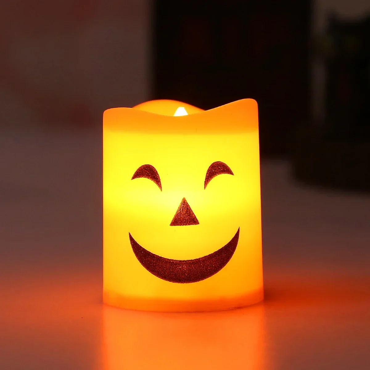 Gr8est orange-yellow LED flameless candle with a smiling jack-o-lantern face for Halloween party decor