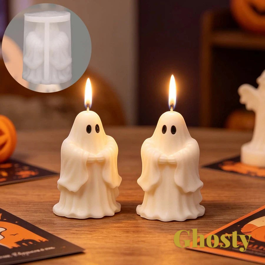 Gr8est saluting ghost silicone candle mold used to create two white ghost-shaped candles with lit wicks on a table.