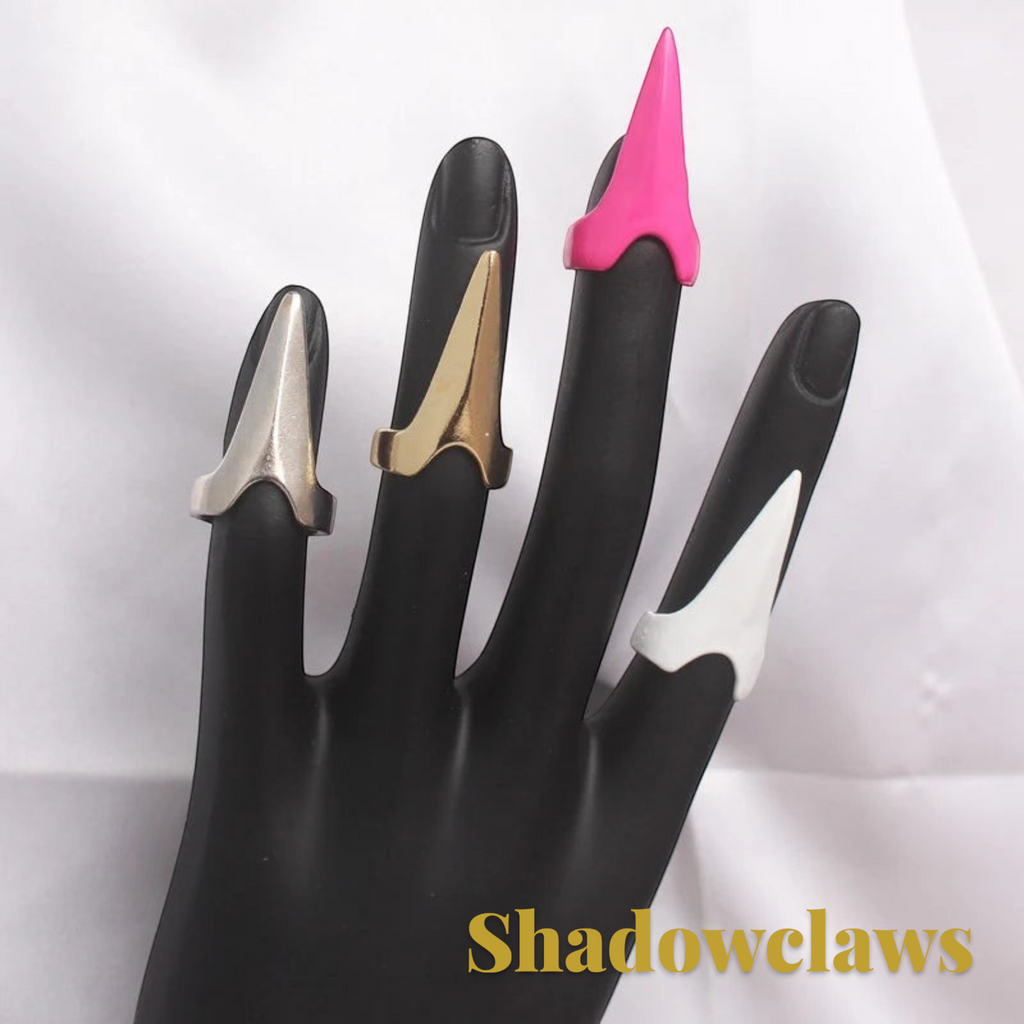 Gr8est Shadowclaws steampunk claw rings in silver, gold, pink, and white worn on a black mannequin hand display