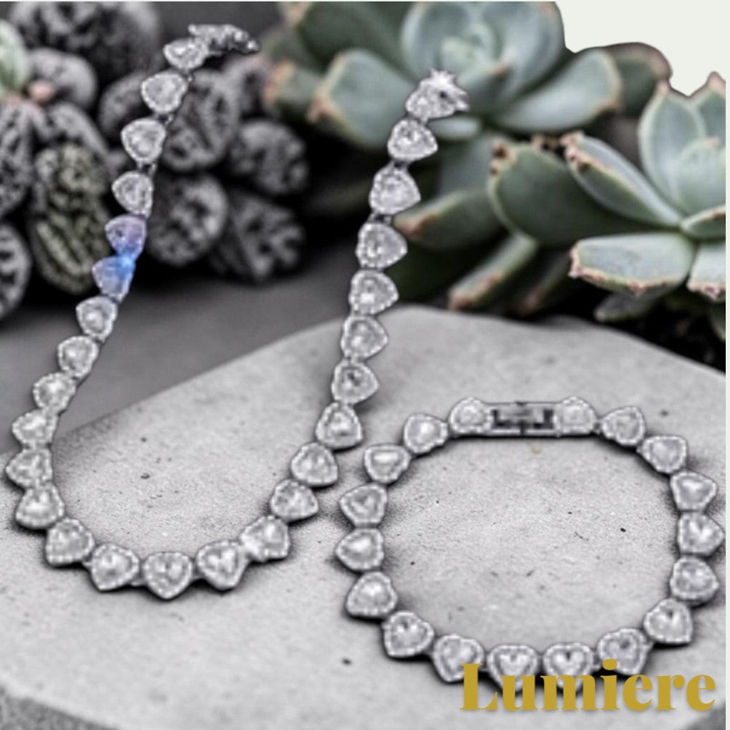 Gr8est silver heart tennis chain necklace and bracelet set with sparkling rhinestones on a black background