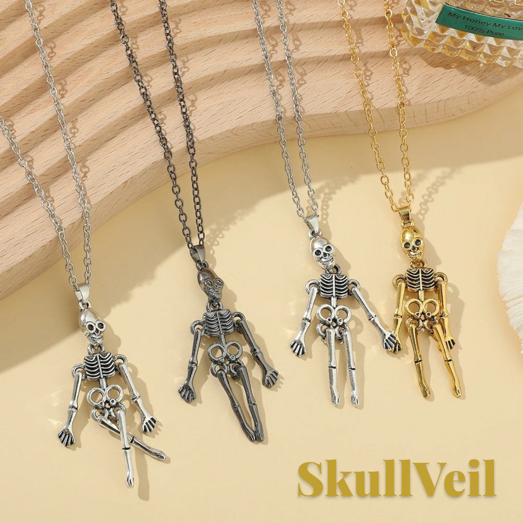 Gr8est gothic skeleton pendant necklaces in silver, black, and gold metal finishes on a wooden display surface