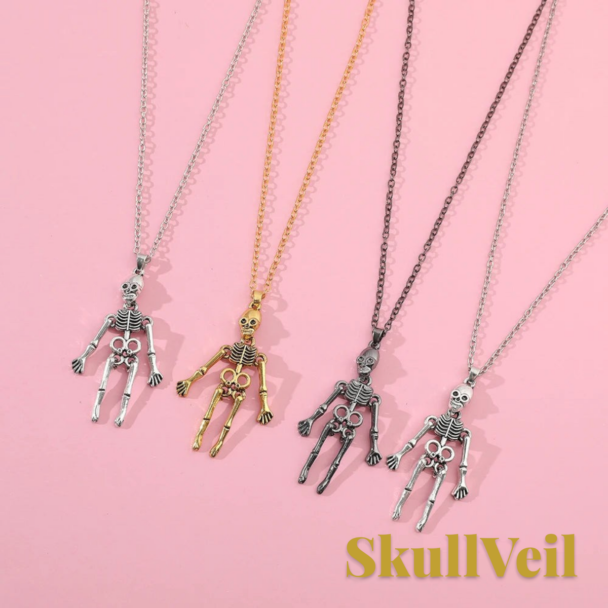 Gr8est Skullveil gothic skeleton pendant necklaces in silver, gold, and dark metal finishes on a pink background