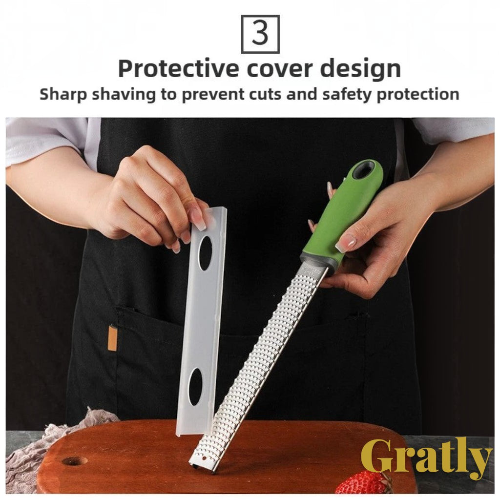 Gr8est stainless steel multi-purpose grater with a green ergonomic handle and protective safety cover.