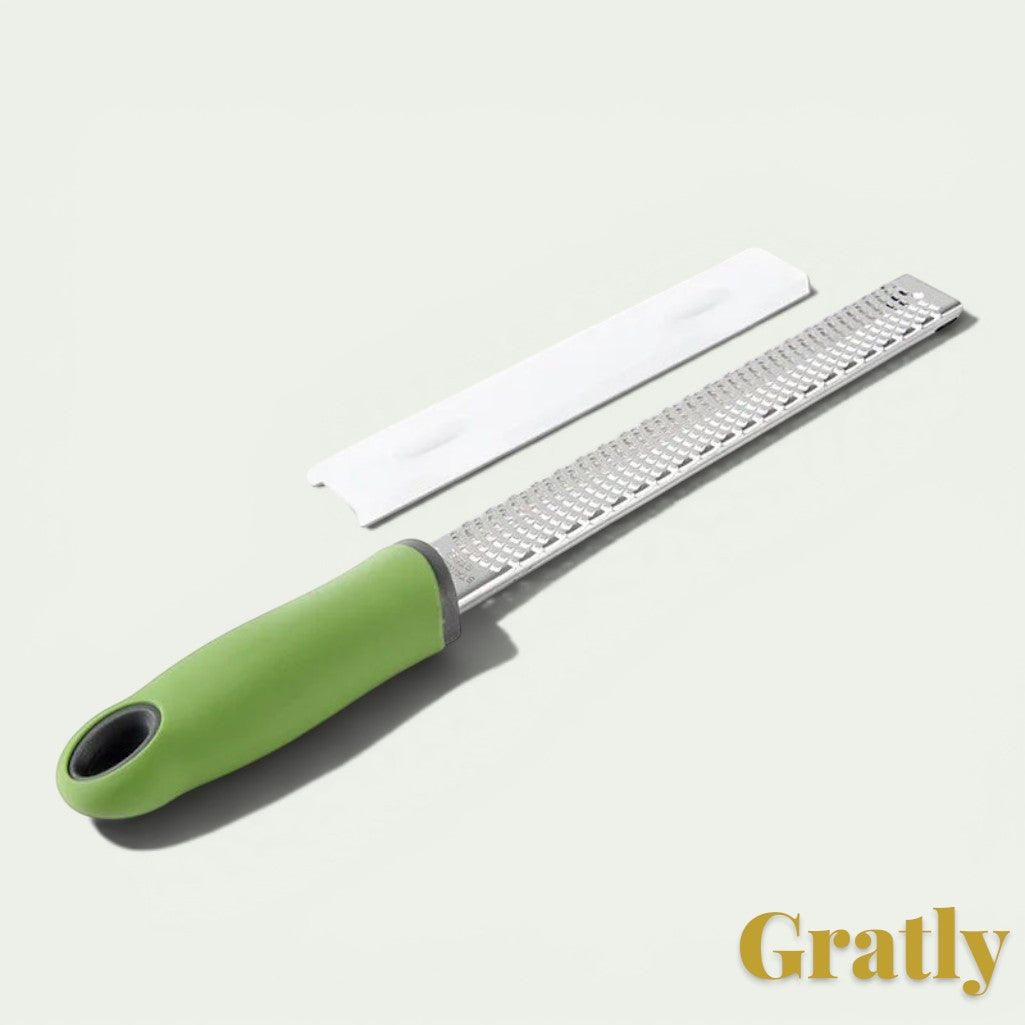 Gr8est stainless steel multi-purpose grater with a green ergonomic handle and a protective plastic cover.
