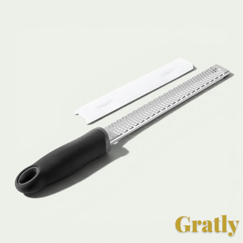 Gr8est stainless steel multi-purpose grater with a black ergonomic handle and protective blade cover.