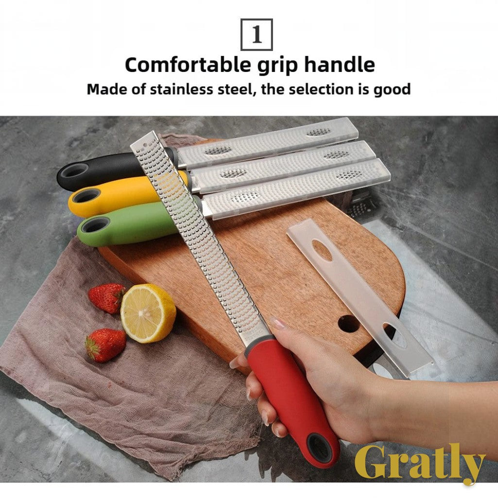 Gr8est Gratly stainless steel multi-purpose grater with ergonomic red handle held over a wooden cutting board
