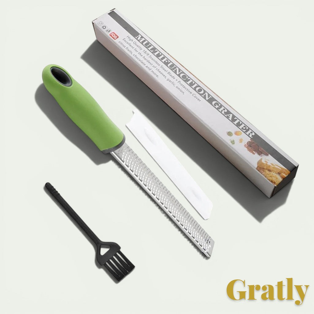 Gr8est stainless steel multi-purpose grater with a green ergonomic handle, protective cover, and cleaning brush.