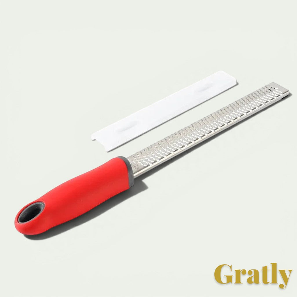 Gr8est stainless steel multi-purpose grater with a red ergonomic handle and protective cover for zesting and grating.