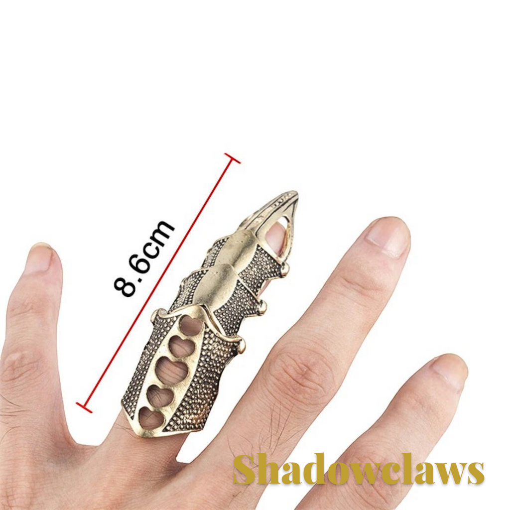 Gr8est steampunk claw ring in antique gold finish worn on a finger, featuring a textured geometric design.