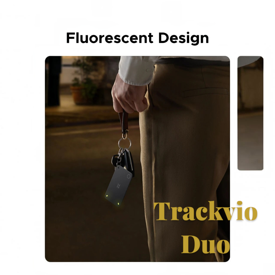 Gr8est UGREEN FineTrack Slim 2 smart tracker with fluorescent accents held by a person with keys in low light